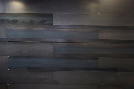 Magnetic metal display ledges on metal wall
