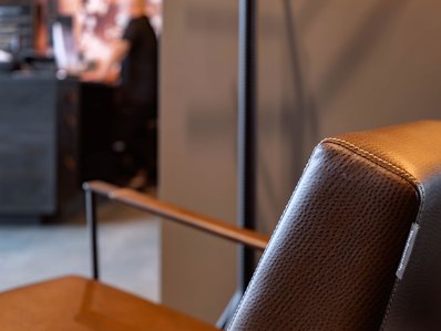 Detail of upholstered lounge chair for mens grooming brand.