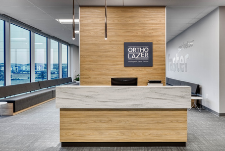 Check in desk area design and build for OrthoLazer health and wellness franchise.