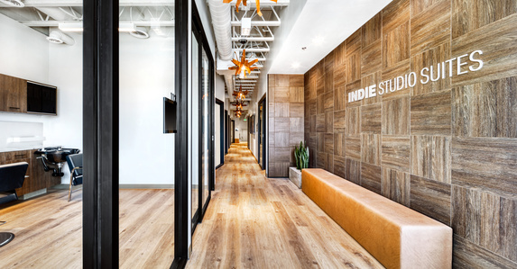 Reception area wall treatment with logo, seating and lighting by Wadsworth Design.
