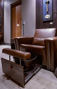 Oversized pedicure lounge chair with pull out bowl support and foot pad.