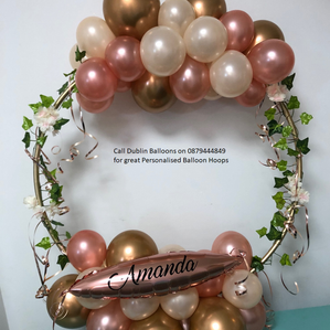 A personalised gold, pink and white balloon hoop for graduation.