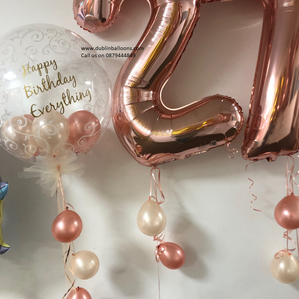 This balloon package consists of a large rose gold number and a large clear personalised balloon.