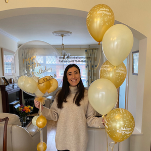 Three gold, two white and a personalised clear balloon display for birthdays.