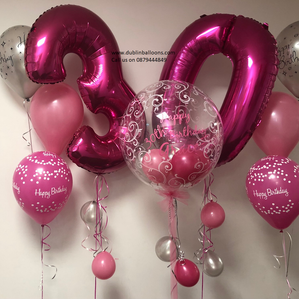 Two large pink balloon numbers, a large personalised clear balloon display and two additional pink birthday  balloon displays for birthdays.