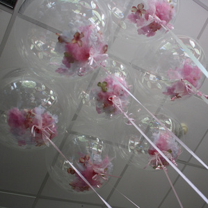 Seven large found floral filled balloons for celebrations.