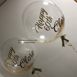 two large large balloons personalised with ostrich feather and personalised text.