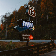 The sign for Route 19 inn motel is lit up in blue hour
