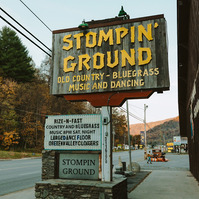 A country dancing sign sits above an empty street.