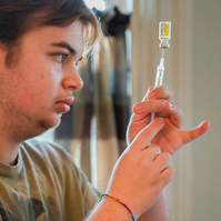 Jay prepares a syringe of his weekly 0.5 ml testosterone shot before injecting it into his thigh.