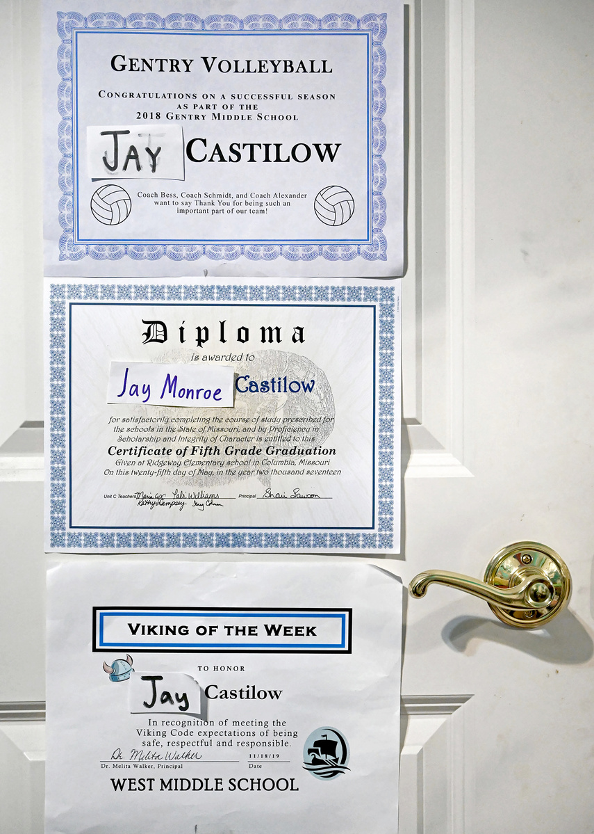 Certificates recognizing Jay’s elementary and middle school achievements hang on his closet door.