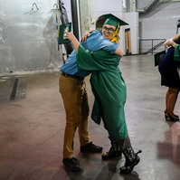 Jay hugs his advanced placement English teacher, Gregory Irwin, after walking in his Rock Bridge High School commencement ceremony at Mizzou Arena.