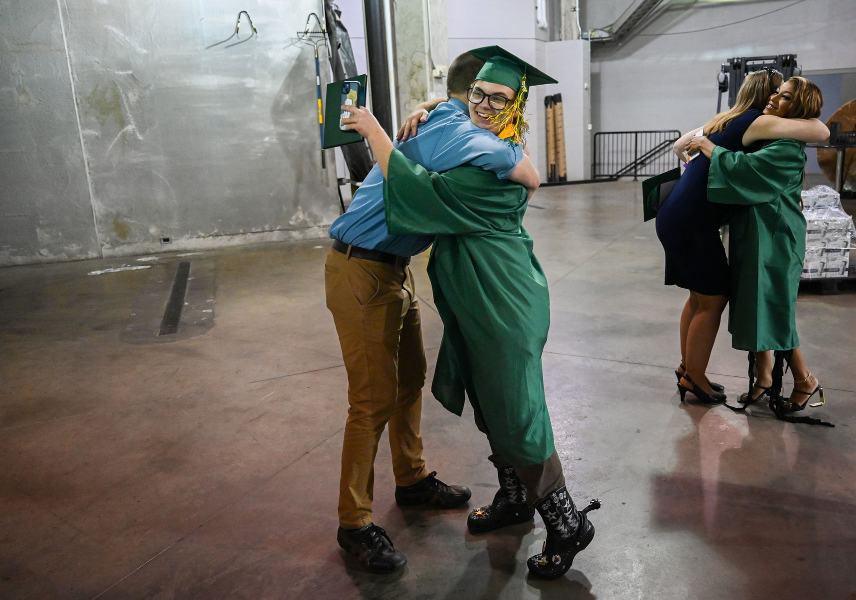 Jay hugs his advanced placement English teacher, Gregory Irwin, after walking in his Rock Bridge High School commencement ceremony at Mizzou Arena.