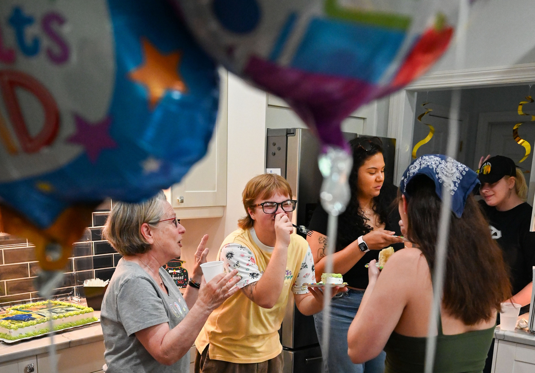 Jay celebrates his high school graduation with friends and family on at his home.
