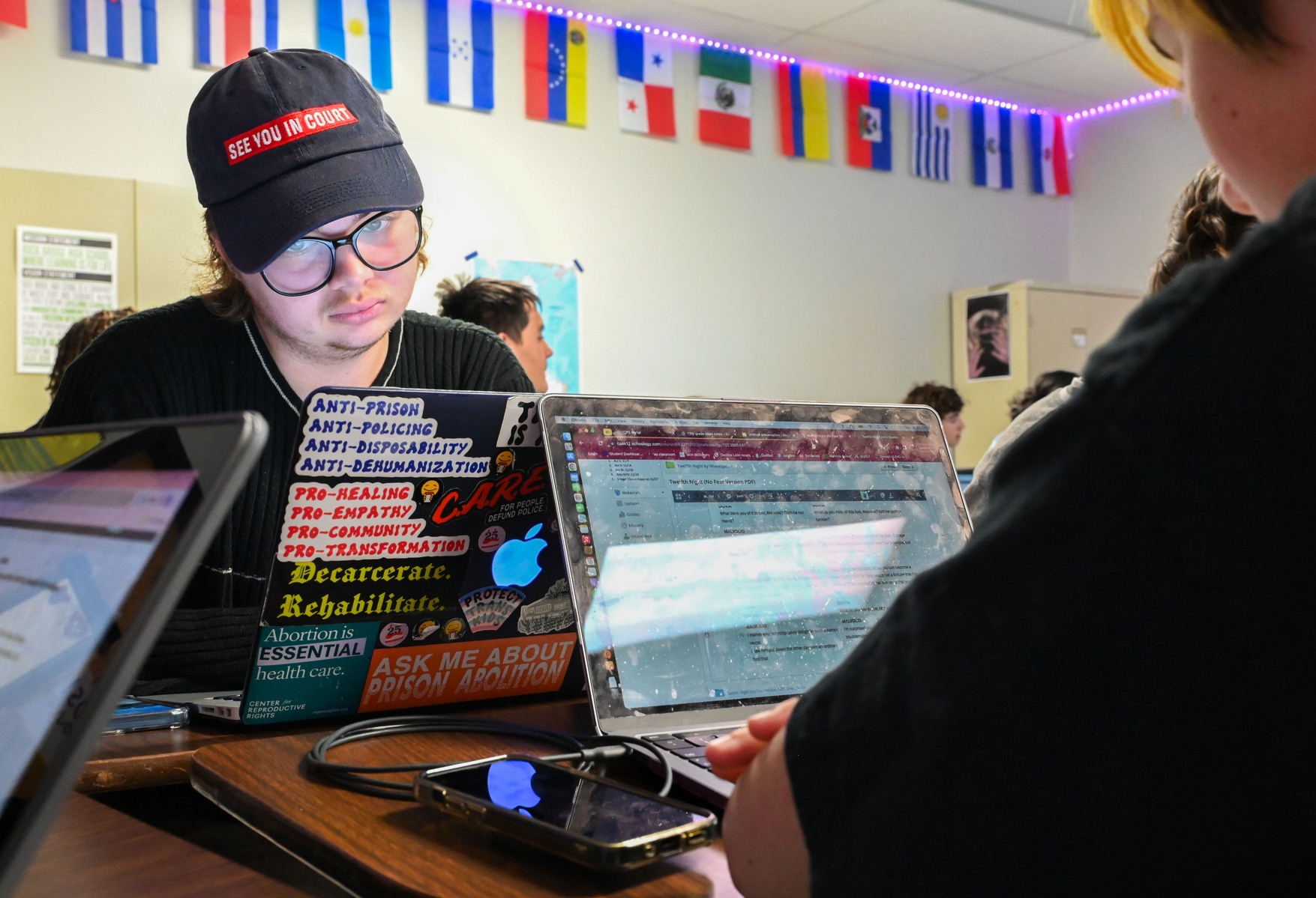 Jay works on his computer, which he has decorated with anti-incarceration, pro-choice and pro-LGBTQ+ rights stickers during English class.