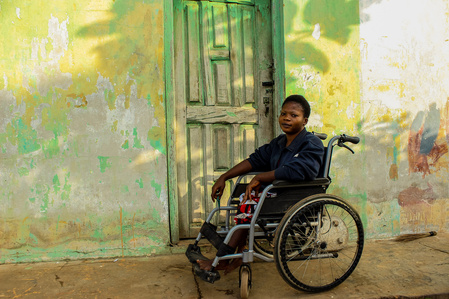 A powerlifting athlete sitting in her wheelchair in front of her hostel. Paralympic Sports Wheelchair Race Powerlifting