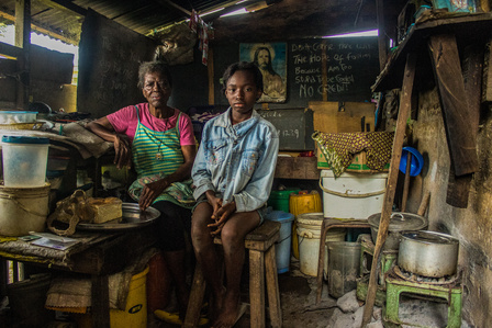 Mama Sckadee and her granddaughter, Angel, both Liberian refugees, inside their kitchen at the Oru International refugee camp, Nigeria.  Liberian Passport Liberia Refugee Civil War