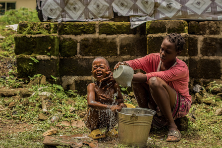 Nene, a Liberian refugee born at Oru International refugee camp, in Nigeria, bathes her brother outside.
Liberia Refugee Civil War