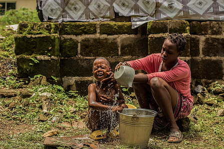 Nene, a Liberian refugee born at Oru International refugee camp, in Nigeria, bathes her brother outside.
Liberia Refugee Civil War