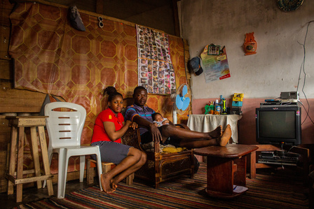 Portrait of James, a Liberian refugee and his family in their room at the Oru International refugee camp, Nigeria.  Liberian Liberia Refugee Civil War
