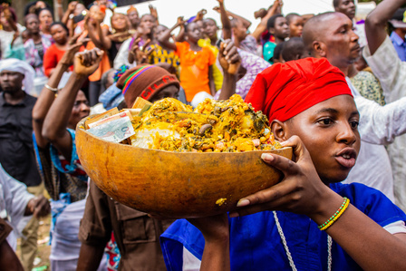 A young Osun priest carries sacrifice at the Ojubo Osun during the grand finale of the celebration of the annual Osun-Oshogbo festival. Festival Culture Tradition