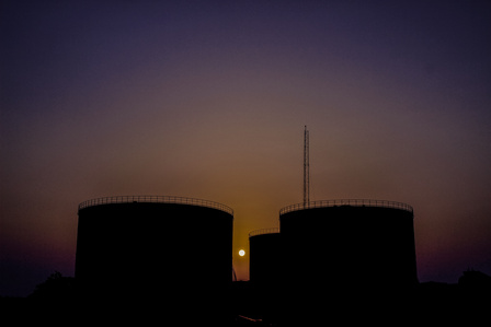 Petroleum products tanks inside the depot at sunset. Oil and Gas