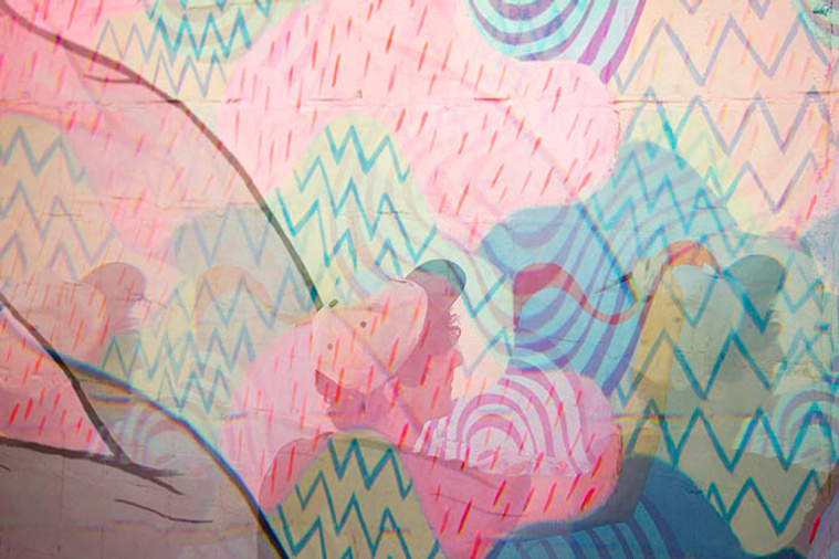 David Peña painting a collaborative mural with Panca 