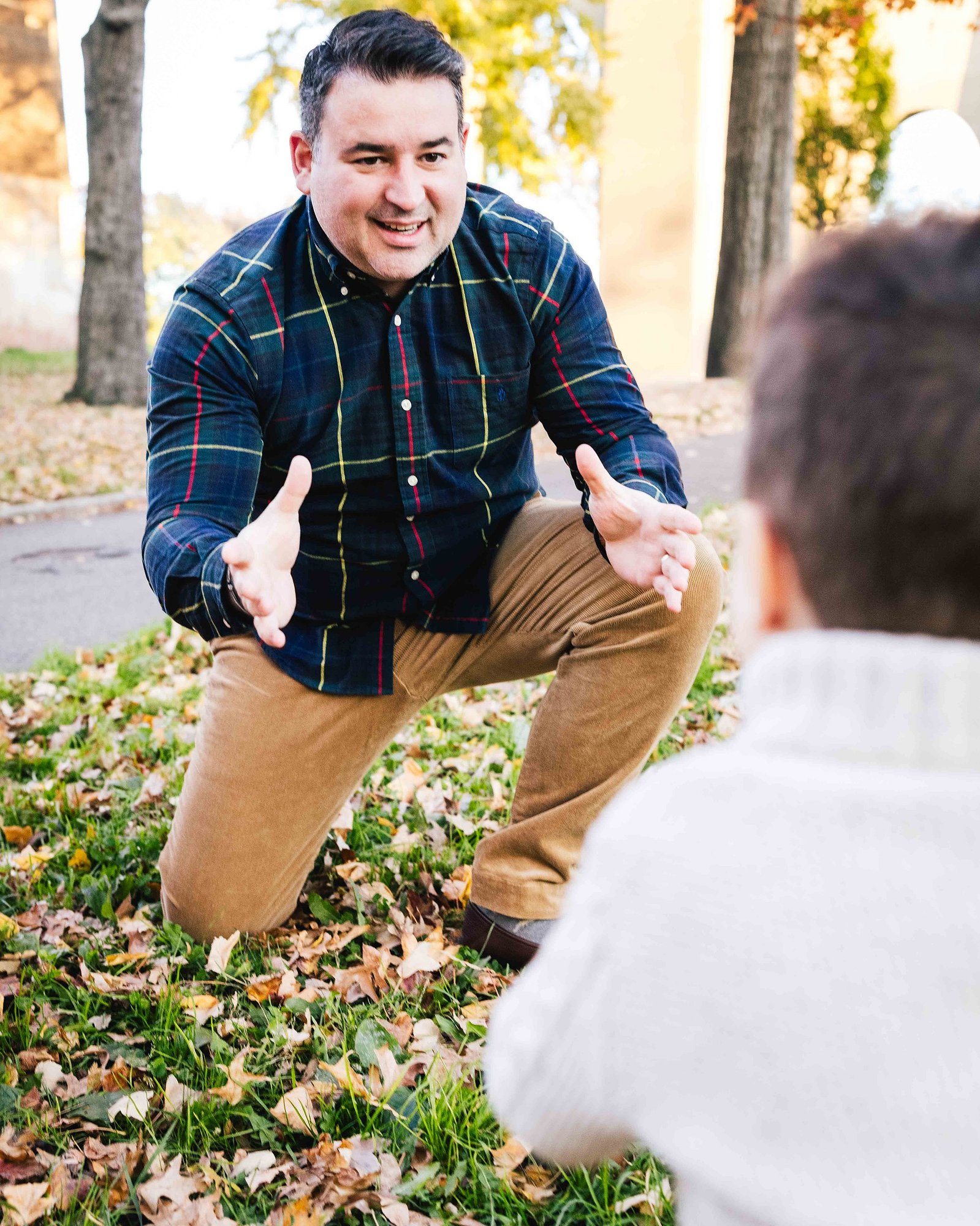 son running into dads arms, in Astoria park family portrait sessions, candid. mc3 photo documentary, styled family portrait session 