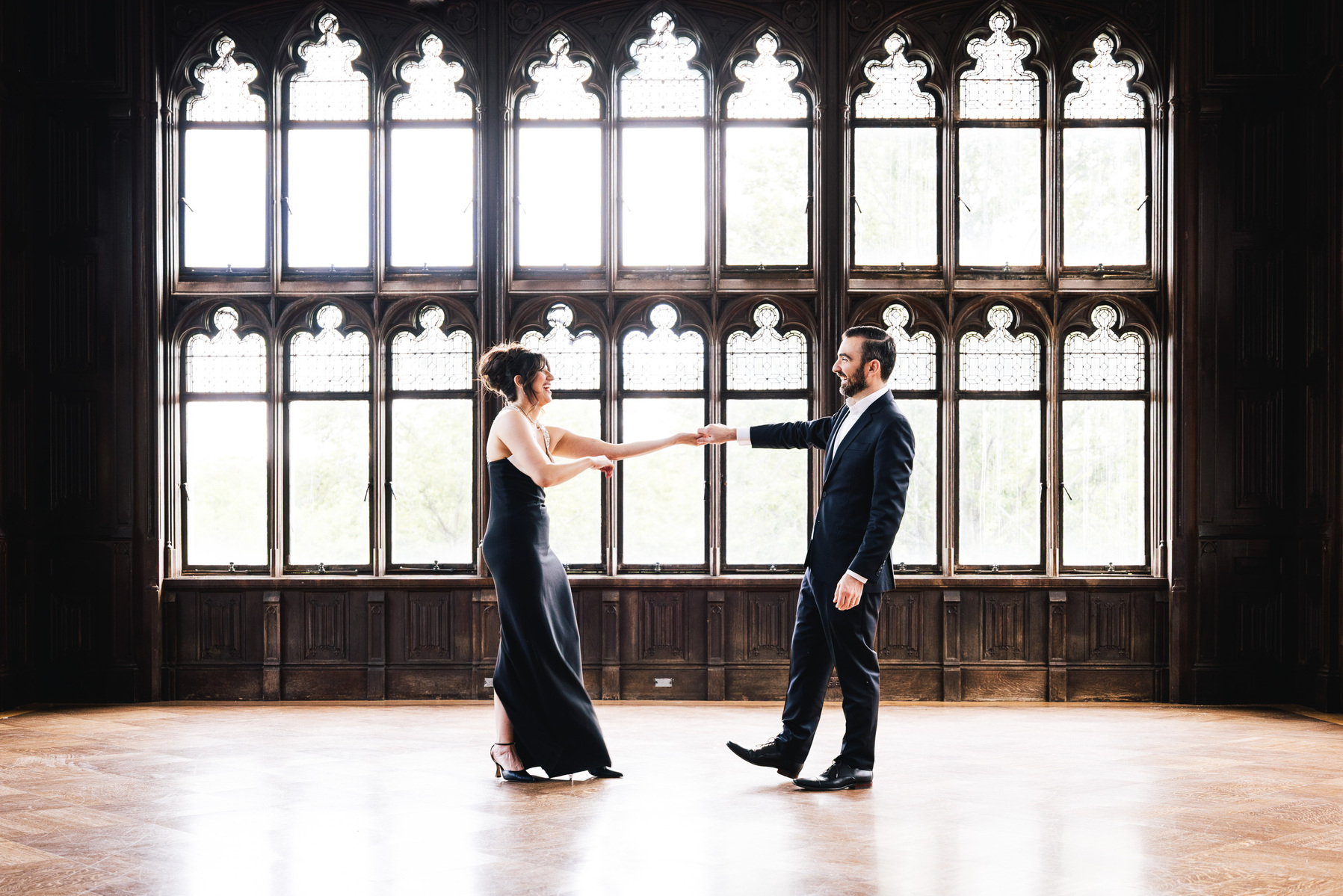 a couple softly dancing, with beautiful soft backlight, smiling, and moving during an nyc engagement session by documentary engagement photographer mc3 photo 