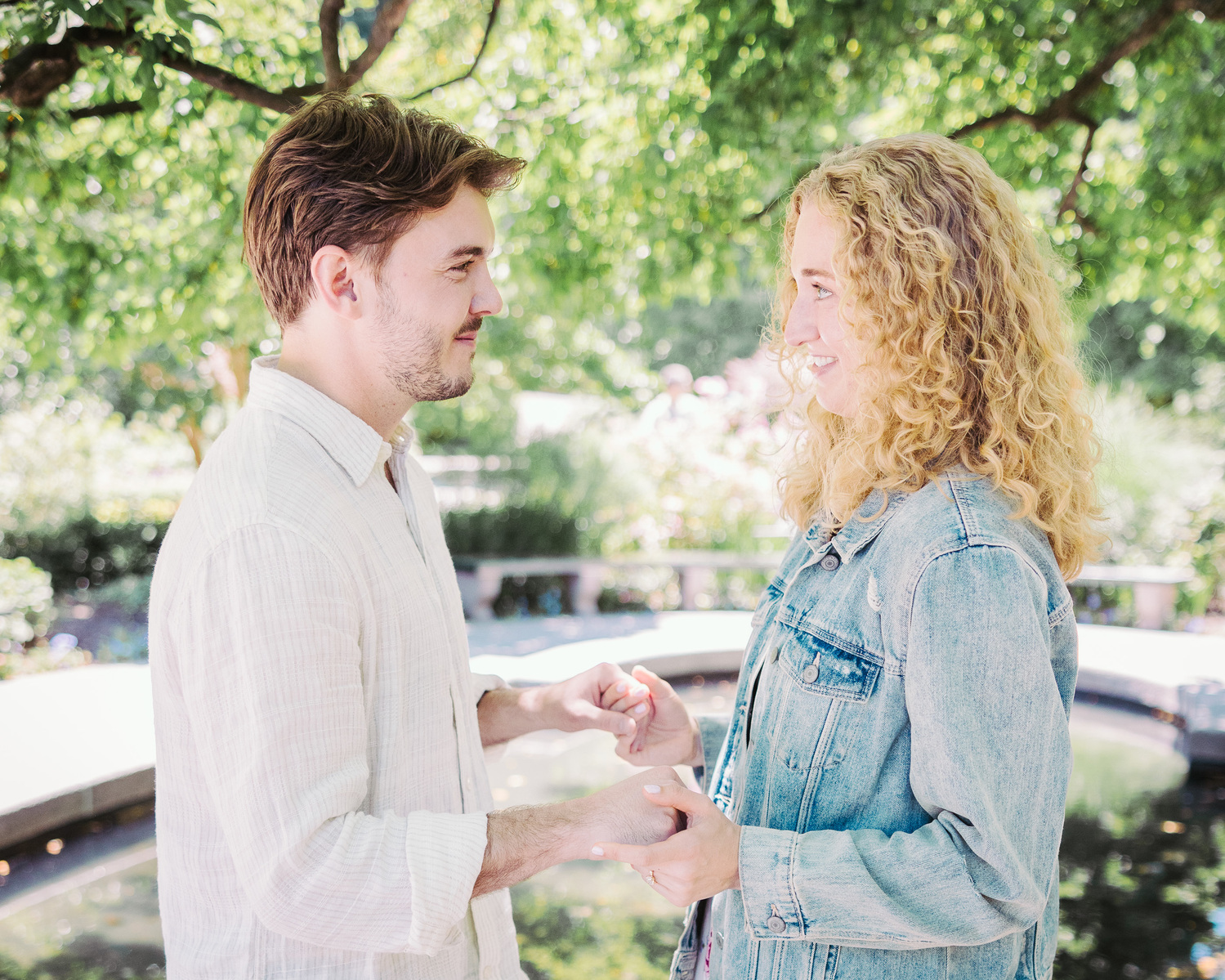 a couples close embrace, during a spring engagement session in Central Park, light and airy, documentary mc3 engagement session 