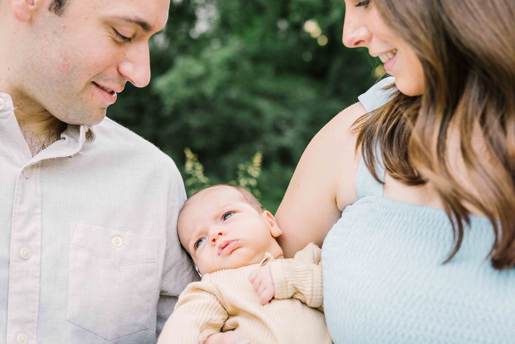 newborn in the arms of mom and dad, during a family portrait session in Central Park, candid quiet moment, by mc3 photo 