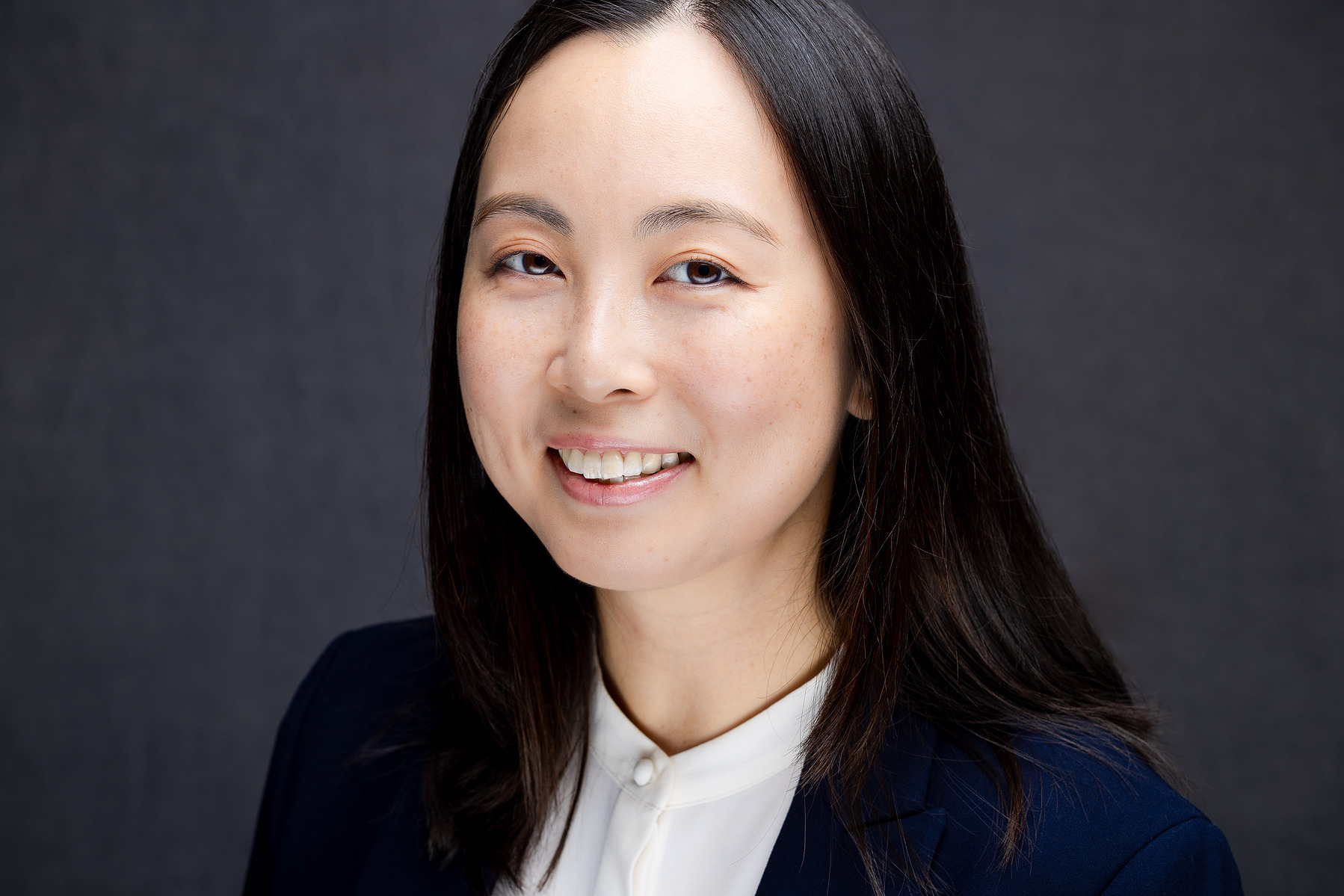Yitong Wang, headshot a white shirt and blue jacket, done by mc3 photo in Long Island city New York 