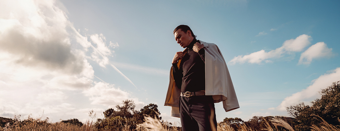 Mitchell Maggard from Wilhelmina models Miami standing alone in a prairie field located in Miramar Florida