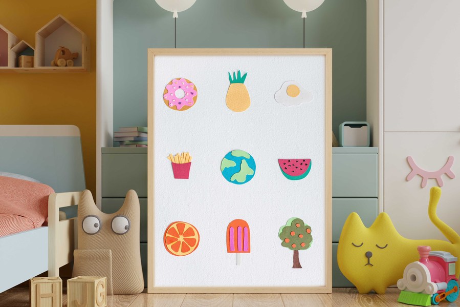 Paper collage of various objects glued onto an 10in x 8in canvas. Hand-cut paper fries, donut, pineapple, egg, earth, watermelon, orange, popsicle and tree. Framed canvas in a kids bedroom. 