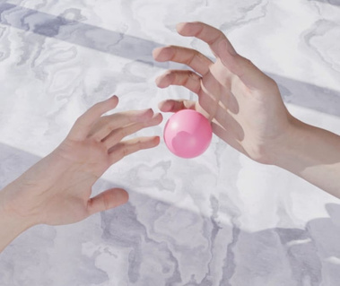 CGI image of two hands playing with pink ball against a marble background