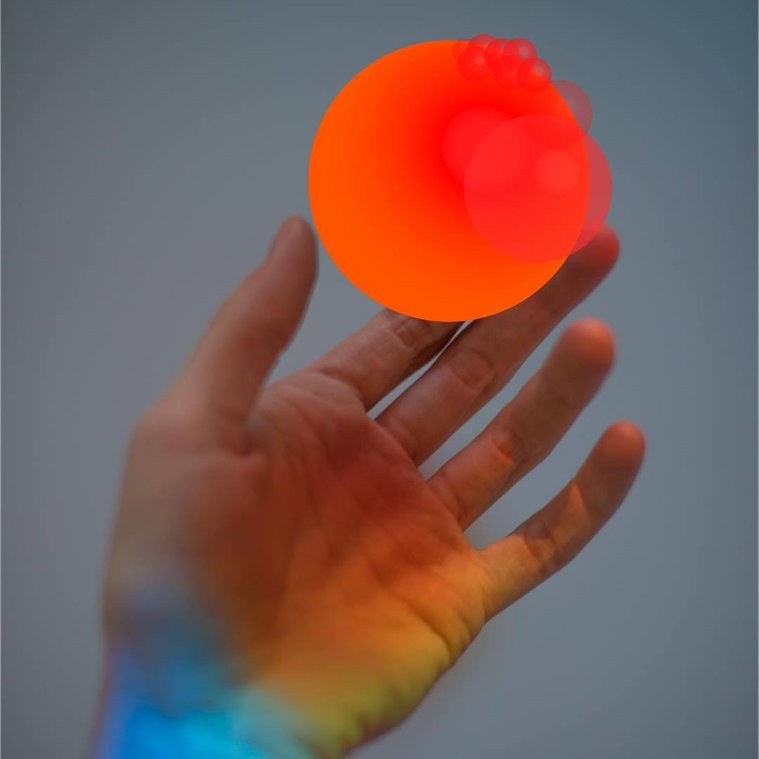 David Stenbeck artwork of a CGI hand holding a ball with rainbow lighting