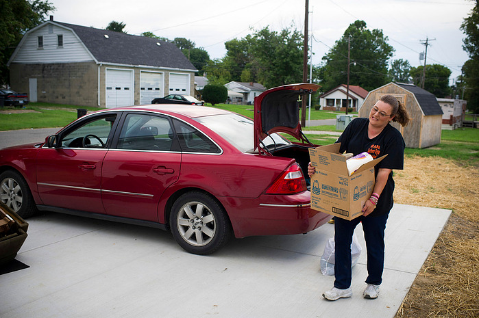 After months of packing, Crystal Causey, unloads boxes into her new home on Fifth Street in Henderson, Monday, Aug. 8, 2016. Causey feels the new neighborhood is safer for her family.