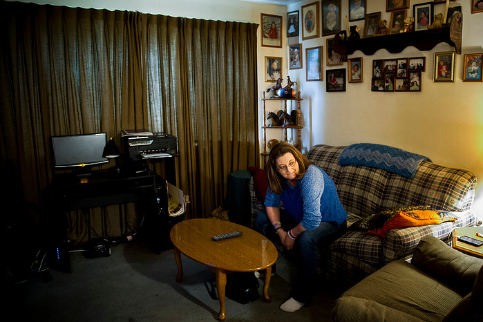 Crystal Causey, of Henderson, sits in her living room in her Henderson apartment, where she lives with daughter, Hannah Turner, 16, and son, Brason Darden, 7, Thursday, May, 26, 2016. The family has lived in a cramped basement apartment with no hot water