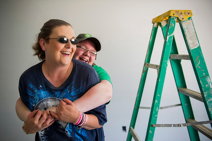 Hannah Turner, 16, hugs her mother, Crystal Causey as they work to paint a room in their new home on Fifth Street in Henderson, Wednesday, June 8, 2016. The new home was built by Habitat for Humanity with help from Causey and her family, "It's a new begin