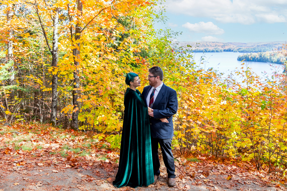Couple shares a joyful moment during their Algonquin Park elopement, surrounded by vibrant fall foliage. Captured by Muskoka wedding photographer Deanna Wagg Photography