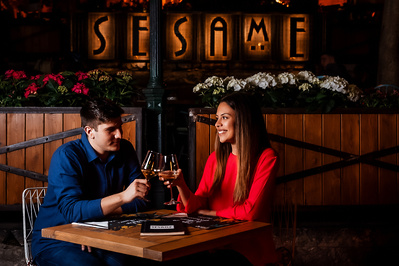 A young couple toasting at an intimate setting in the evening at Sesame restaurant in Dubrovnik.