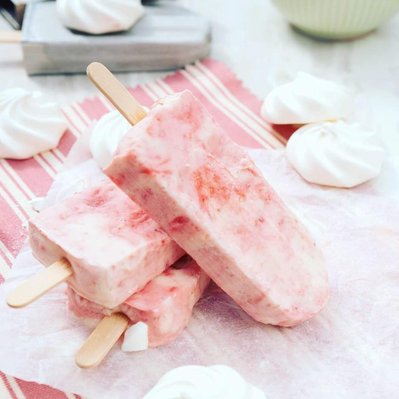 strawberries and crem ice lollies on baking paper with meringues popcicles summer treat, refreshing snack