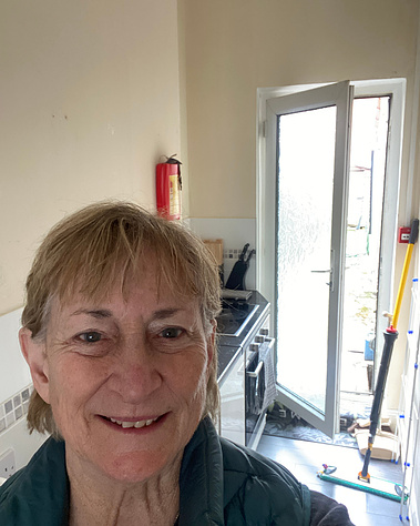 Here's the kitchen area, along with the back door that I can't seem to figure out how to open.  Landlady and I opened it yesterday, but today it is a mystery!