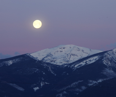 Full moon setting over the Bitterroot Range in Western Montana