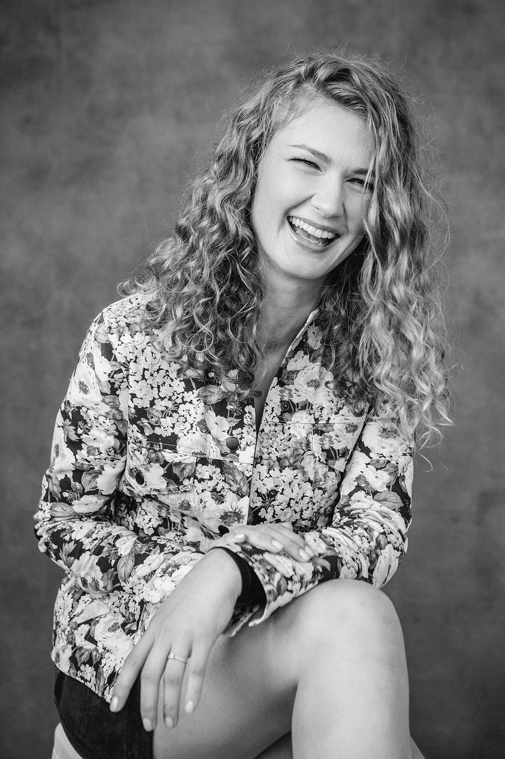 A young woman with blonde naturally curly hair 