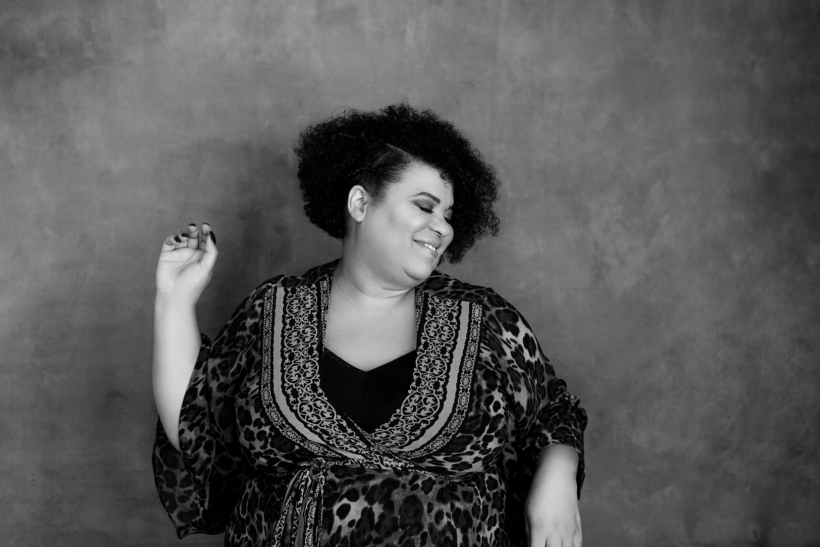 A beautiful black woman dances with joy