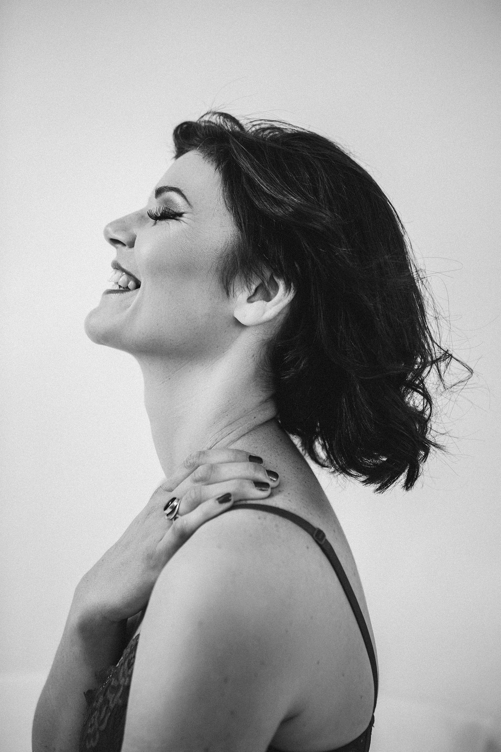 Side profile of a woman laughing joyfully