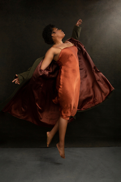 A dancer jumps into the air, looking like she is floating