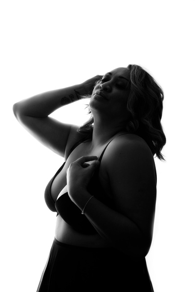 A curvaceous woman is silhouetted against a white background
