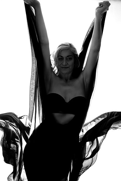 A striking woman throws her sheer shirts upwards